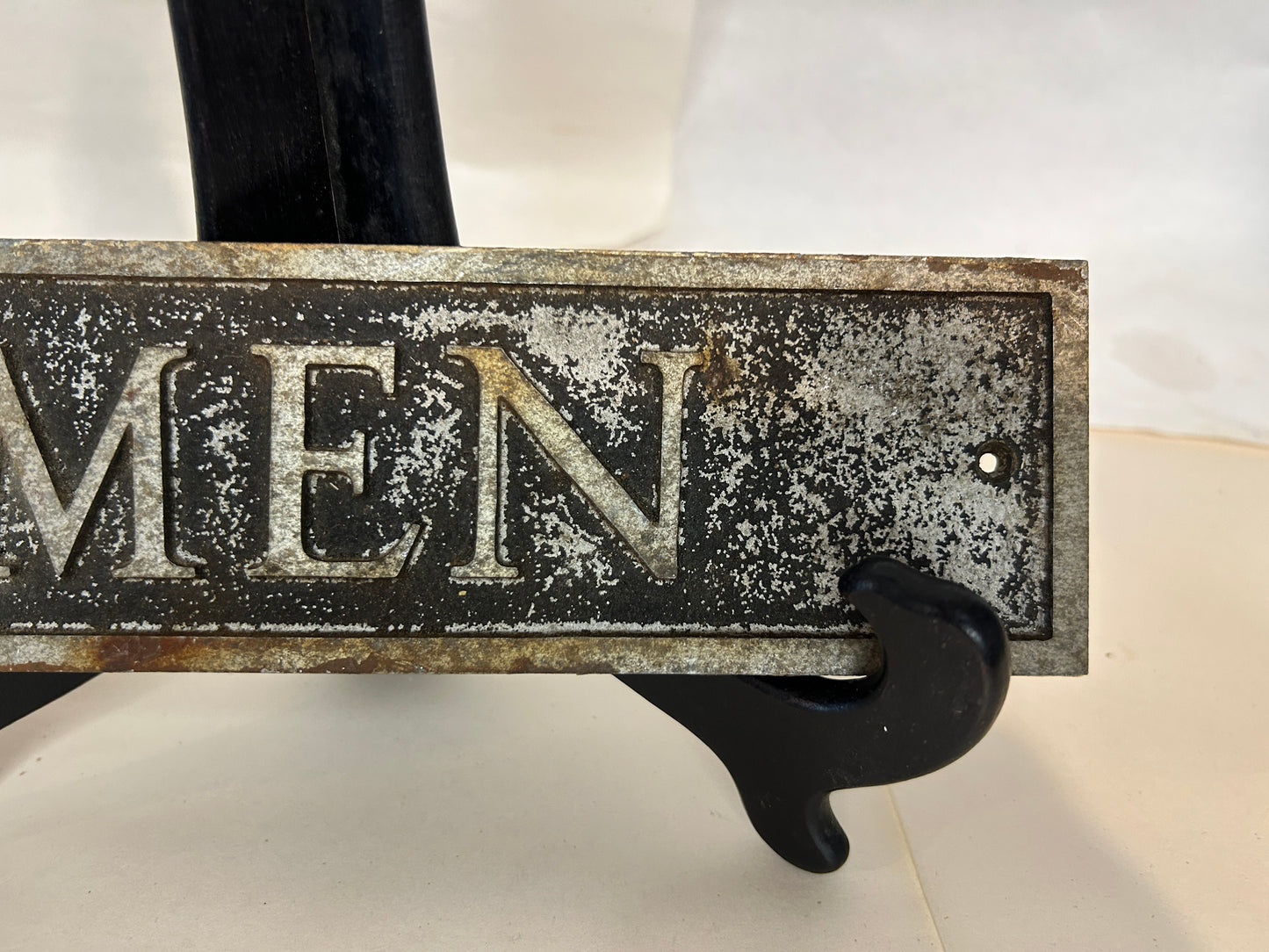 Vintage Cast Iron “MEN” Sign Hangs Flush to the Wall